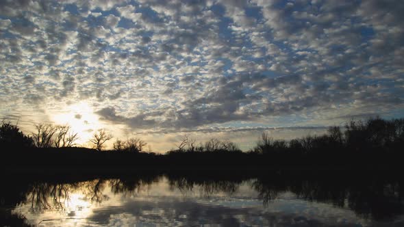 Brilliant Sunrise Clouds Over Lake Zoom In Timelapse