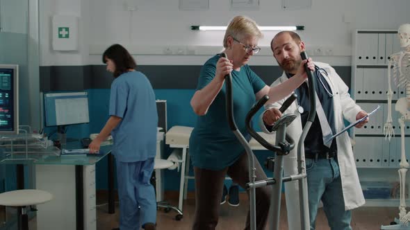 Senior Patient Doing Muscle Exercise on Stationary Bicycle alt