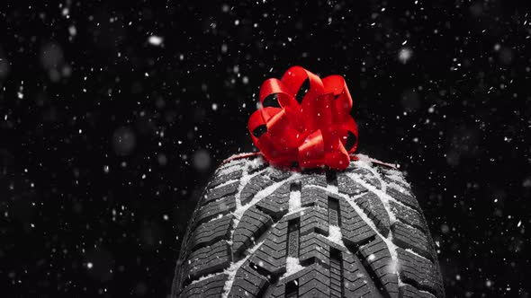 black isolation rubber tire, on the grey backgrounds in a bow for christmas alt