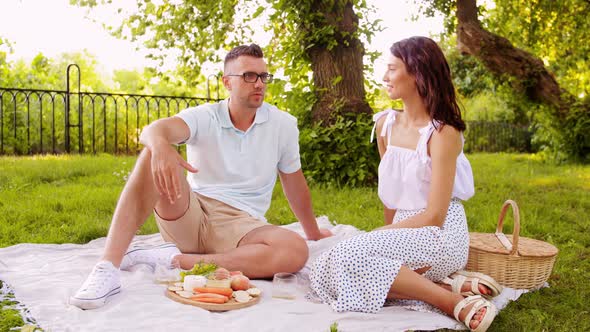 Happy Couple Having Picnic at Summer Park alt