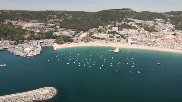 Motorboats and yachts anchored on calm Atlantic Ocean off Ouro Beach, Sesimbra alt