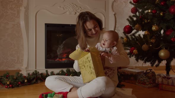 Mom and Child Open New Year's Gifts