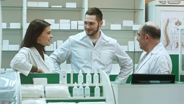 Team of pharmacist chemist woman and man standing in pharmacy