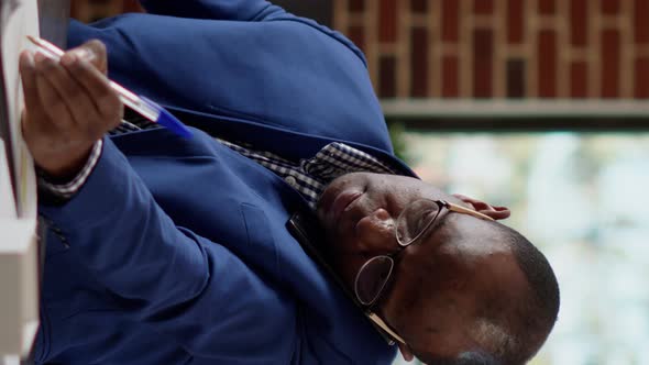 Vertical Video Company Employee Talking on Mobile Phone Call in Office alt