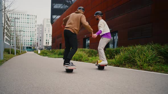 Men Riding Electric Skateboards alt