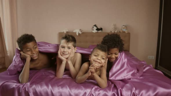 Smiling Boys Under Blanket. alt