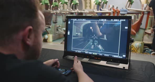 Director at the Workplace on the Set Looks at the Playback Screen
