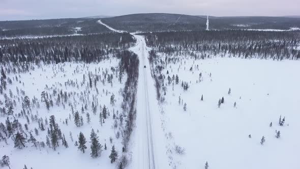 Car on a snowy winter road alt