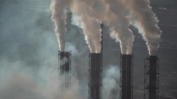 large amount of smoke and soot is emitted from the factory pipes of the metallurgical plant alt