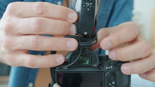 Closeup of Male Hands Working with Modern Camera While Blogger is Ready for Recording Video alt