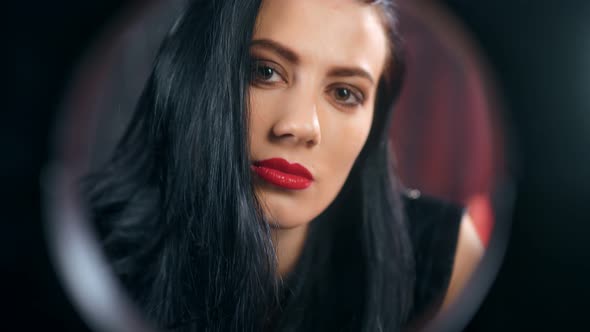 Face of Sensual Domination Female in Latex Contemplating From Black Circle Frame Feeling Passion alt