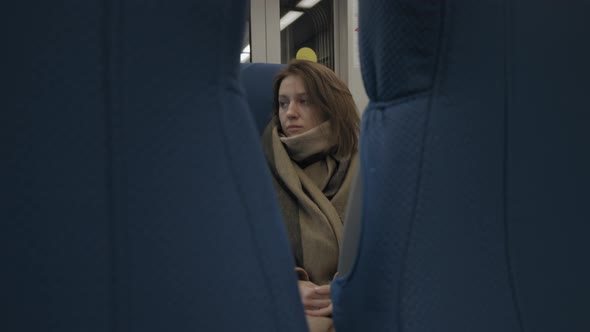 Young Woman Riding Train In Countryside alt