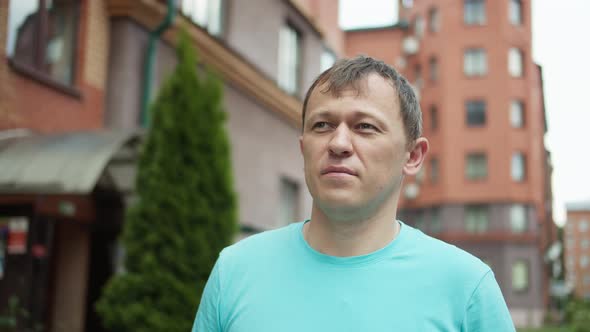 Young man walking in the city, camera tracking