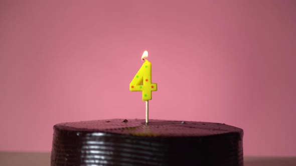 Chocolate Birthday Cake with Wick Lighting Trying to Blowout Candle alt