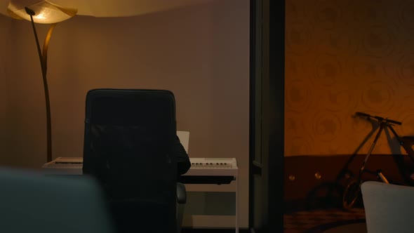 Young Composer Songwriter Playing on Piano and Goes to Laptop for Record alt