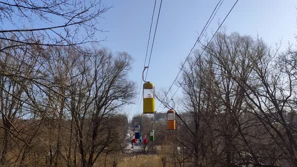 Colored cableway cabins in spring, entertainment