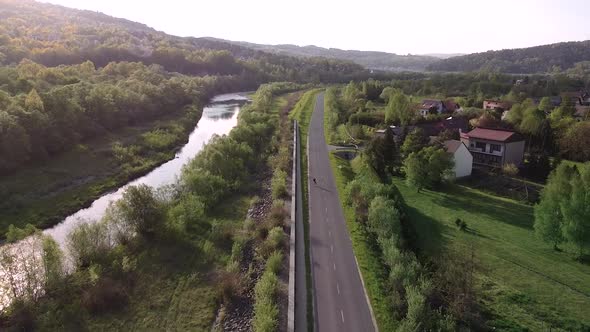 sunset roller skating on the long lonely road aerial shot alt