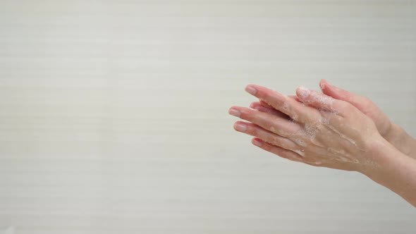 A Woman Washes Her Hands with Soap. Soap Suds on the Hands. Demonstration of Hand Washing To Protect alt
