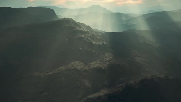 Black Volcanic Dust and Mountains with Fog in Background alt