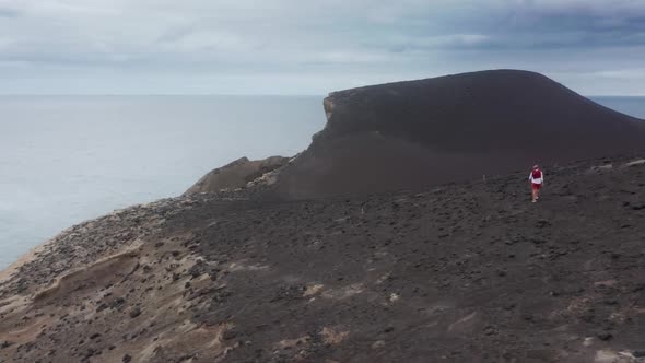 Man Exploring Volcanic Area of Capelinhos Volcano Faial Island Azores alt