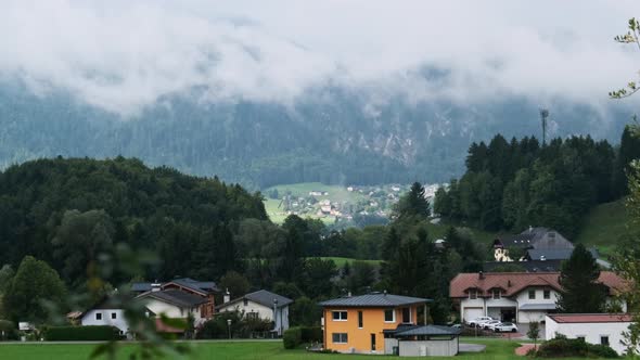 Austrian Rural Landscape with Mountains Houses and Green Lawns alt