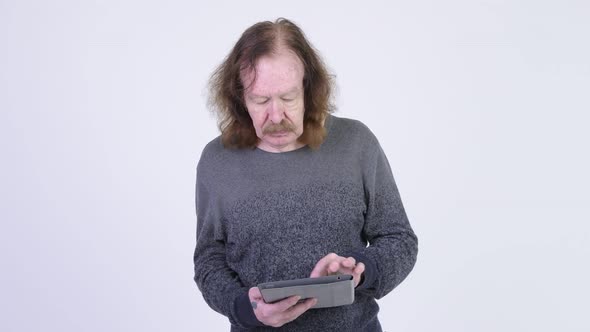 Happy Senior Man with Mustache Using Digital Tablet alt