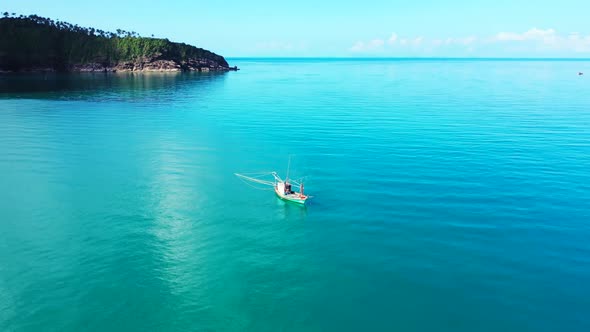 Aerial flying over travel of marine tourist beach wildlife by blue green sea with white sand backgro alt
