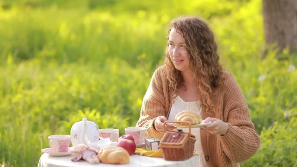 A beautiful couple in love on a picnic. A young model and a beautiful smiling guy. Summer