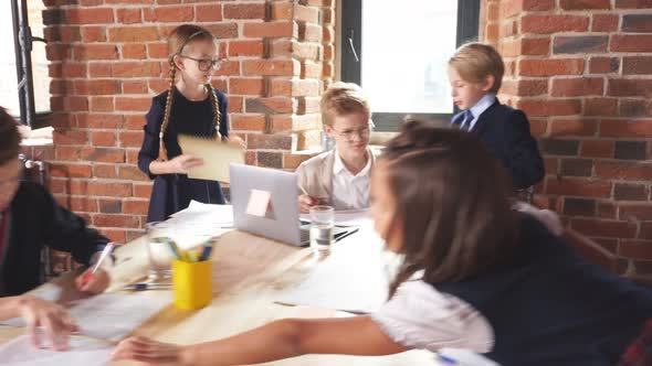 Smart Little Ginger Boy in Glasses Working on Computer, Taking Notes alt