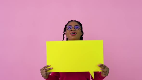 Young African American Girl Stands with Posters for Expression on a Solid Pink Background alt