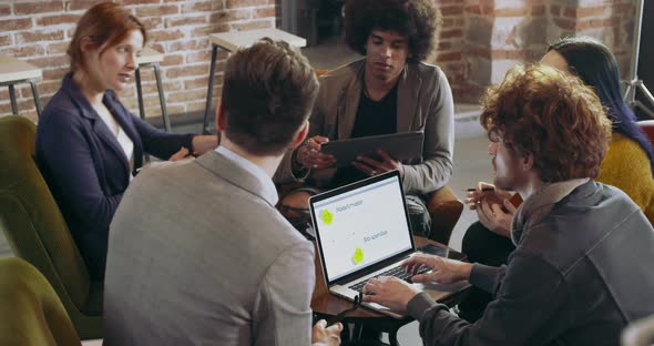 Colleagues and Clients Talking Strategy with Laptop and Tablet alt