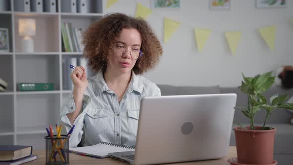 Modern Training Young Woman with Glasses Undergoes Online Training and Communicates with Teacher Via alt