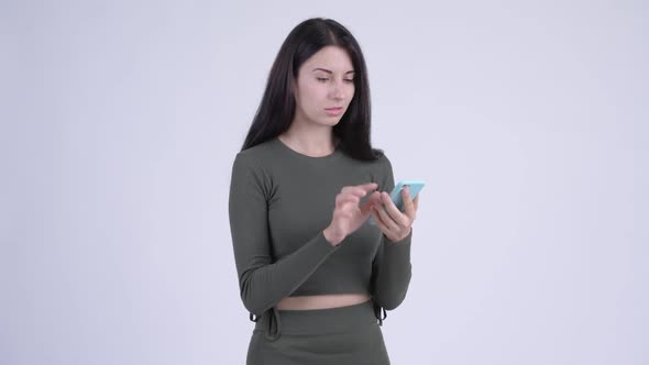 Happy Young Beautiful Woman Using Phone and Getting Good News alt