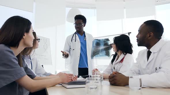 Young Students Applauding to Their Male Teacher alt