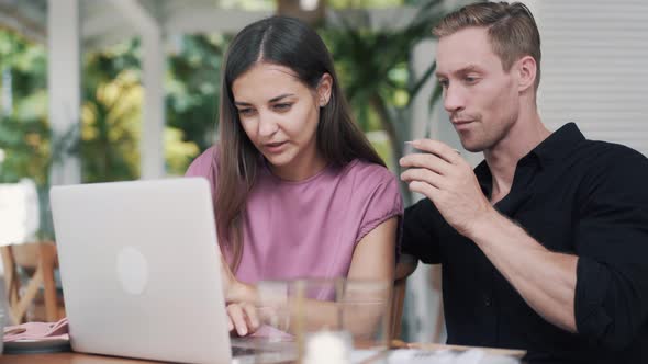 Business Partners, Woman and Man Work in Cafe, Use Laptop, Discuss Project alt