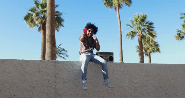 African american man listening music with vintage boombox stereo outdoor alt