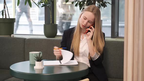 Busy Successful Woman in Suit Working in Cafe