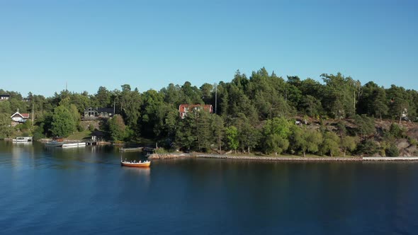 Archipelago in Scandinavia, Northern Europe. Small outboard rowboat with passengers