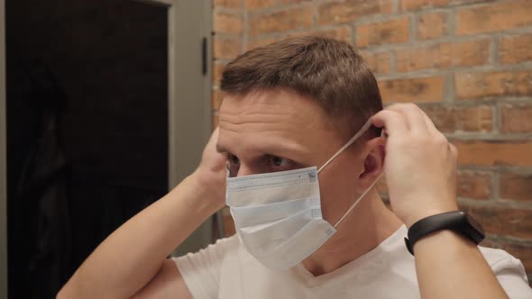 Man Home Puts Medical Mask
