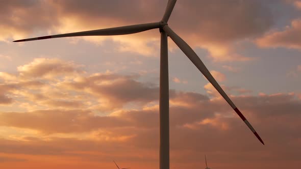 Windmills with Huge Propellers Produce Electricity at Sunset