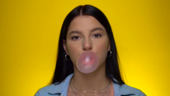 Smiling Woman Looking at Camera Chawing Blowing Pink Bubble Gum Slow Motion