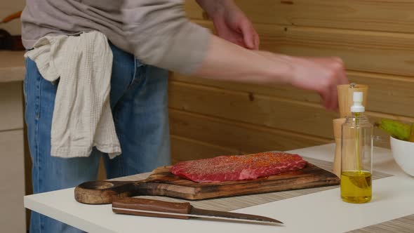 Rubbing Mixture Of Spice And Herbs Into Beefsteak alt