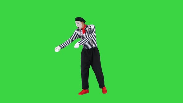 Male Mime Artist Performing Pulling Virtual Rope on a Green Screen Chroma Key alt