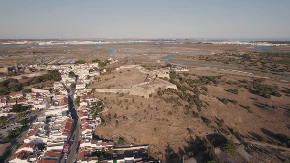 Aerial descending shot of Forte de Sao Sebastiao in Castro Marim, Algarve, Portugal. alt