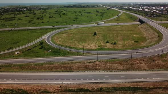 Aerial View of Modern Highway Road Intersection with Traffic Circle on Rural Landscape alt