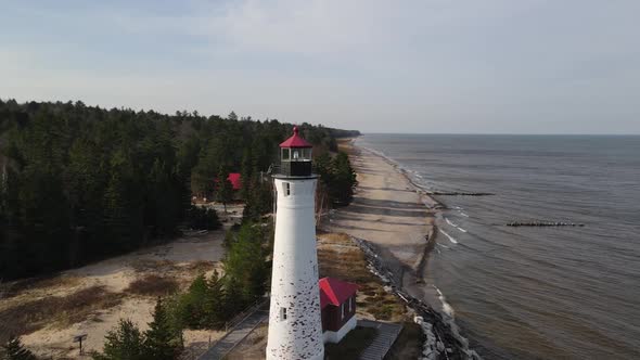 4k drone footage of Crisp Point Lighthouse in Michigan during the fall. alt