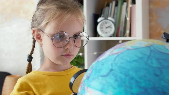 Portrait of a Child with a Globe