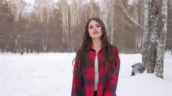 Charming Female with Long Hair Walking in Snowy Forest