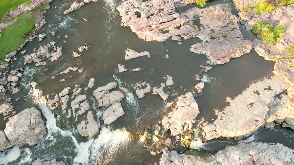 Overhead view off water falls in Falls Park, Sioux Falls, South Dakota, on a sunny day.