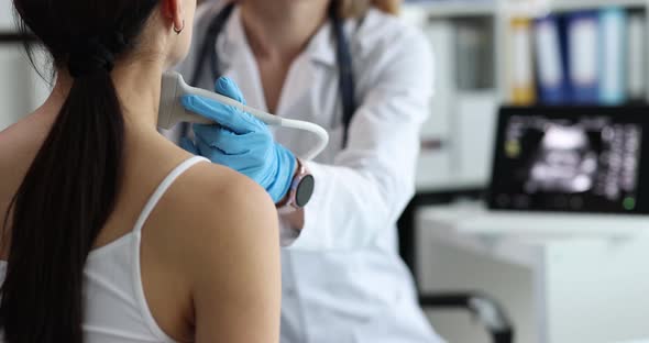 Doctor Makes Ultrasound Scan of Thyroid Gland Closeup alt
